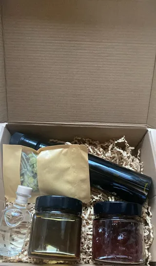 Albania in a Box gift set featuring olive oil, honey, and raki from Saranda