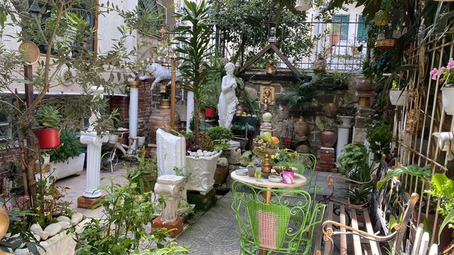 Family Pot Kitchen outdoor garden dining area with Mediterranean flowers in Saranda Albania